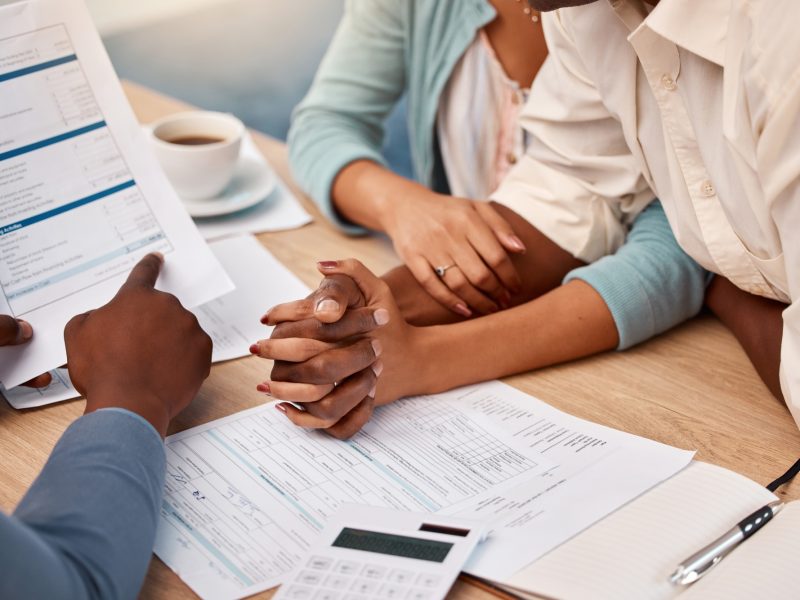Insurance, contract and a couple with an advisor for mortgage, loan or help with taxes. Holding han